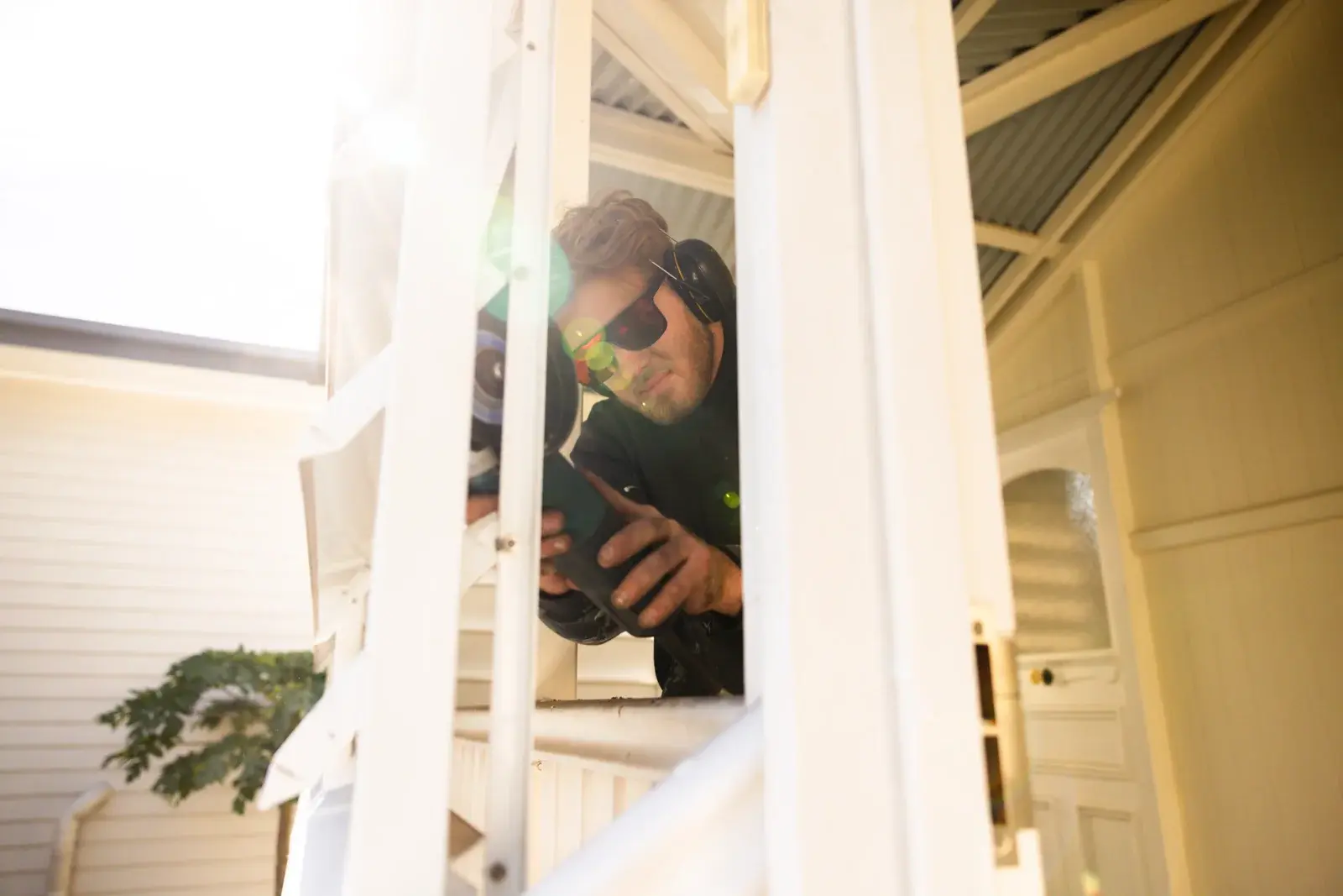 Farr Constructions builder cutting timber on site during Queenslander verandah renovation in Brisbane