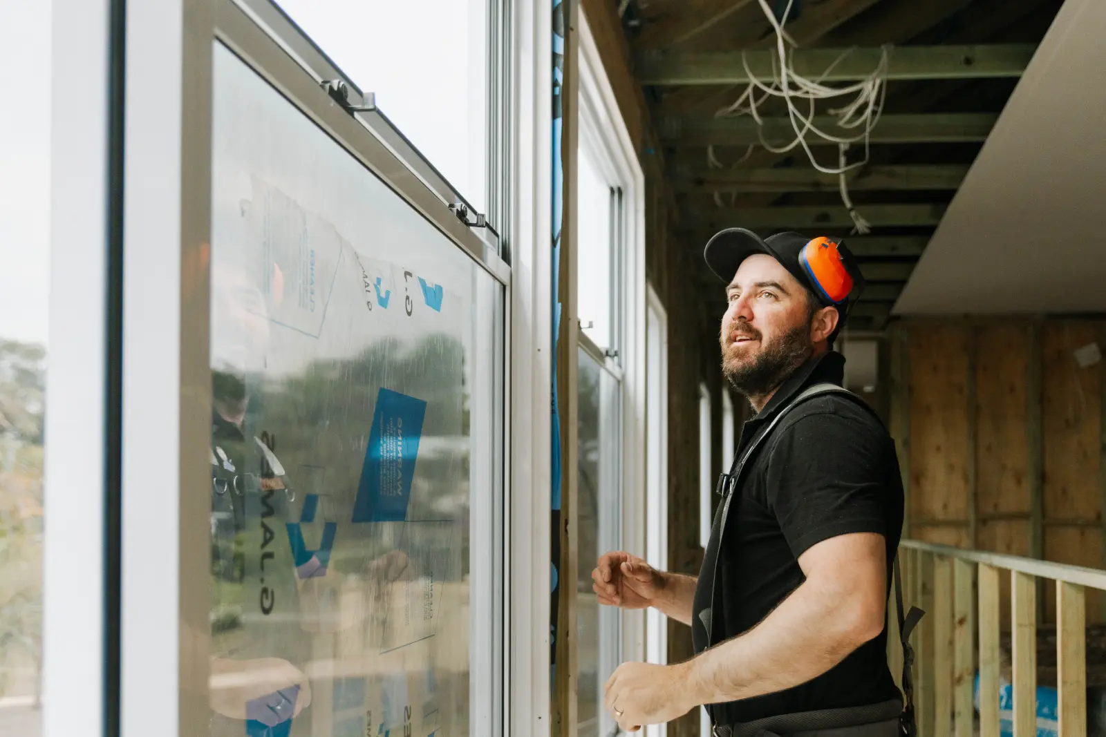 Farr Constructions carpenter installing windows on site, Brisbane