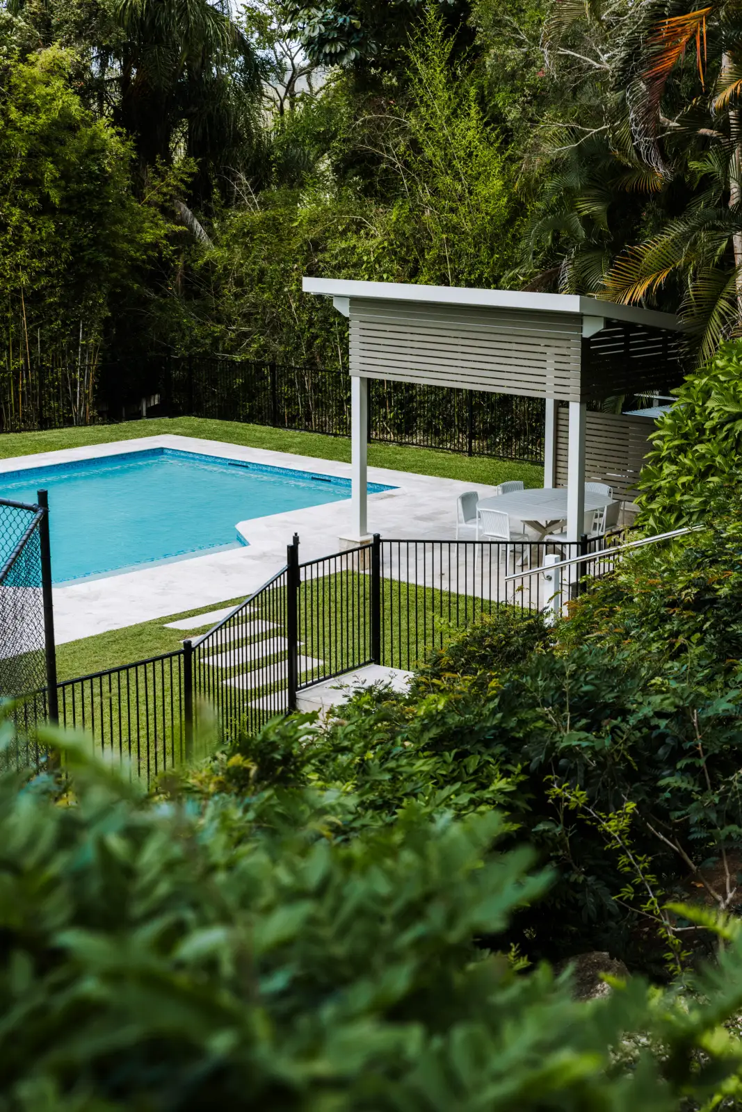 Completed pool and outdoor pavilion with lush garden by Farr Constructions, Brisbane