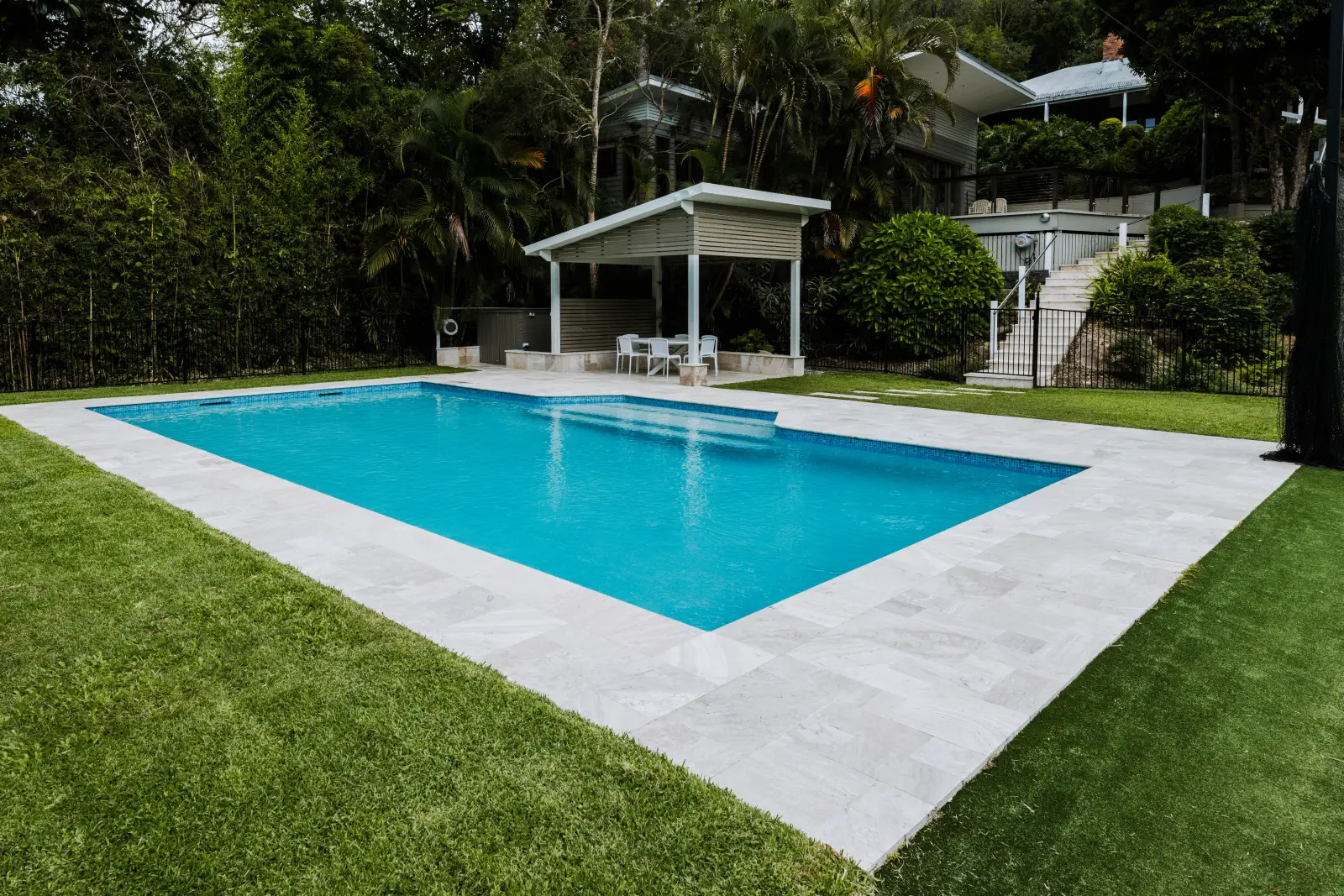 Completed concrete pool installation with stone surround and pavilion by Farr Constructions, Brisbane