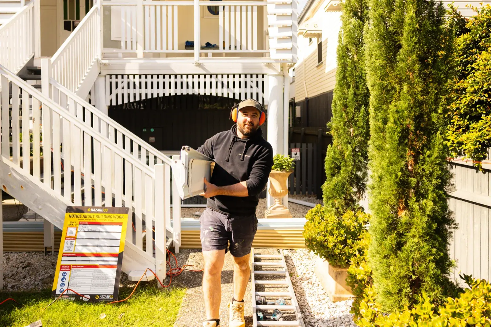 Farr Constructions contractor carrying materials on site during Queenslander home renovation in Brisbane