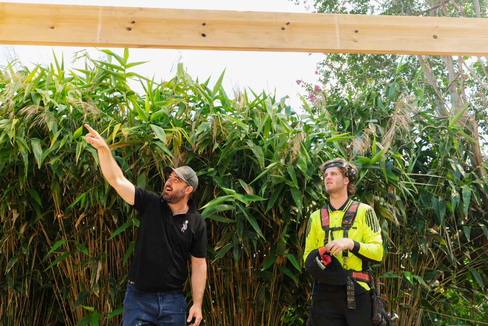 Farr Constructions builder team planning timber beam placement on site, Brisbane