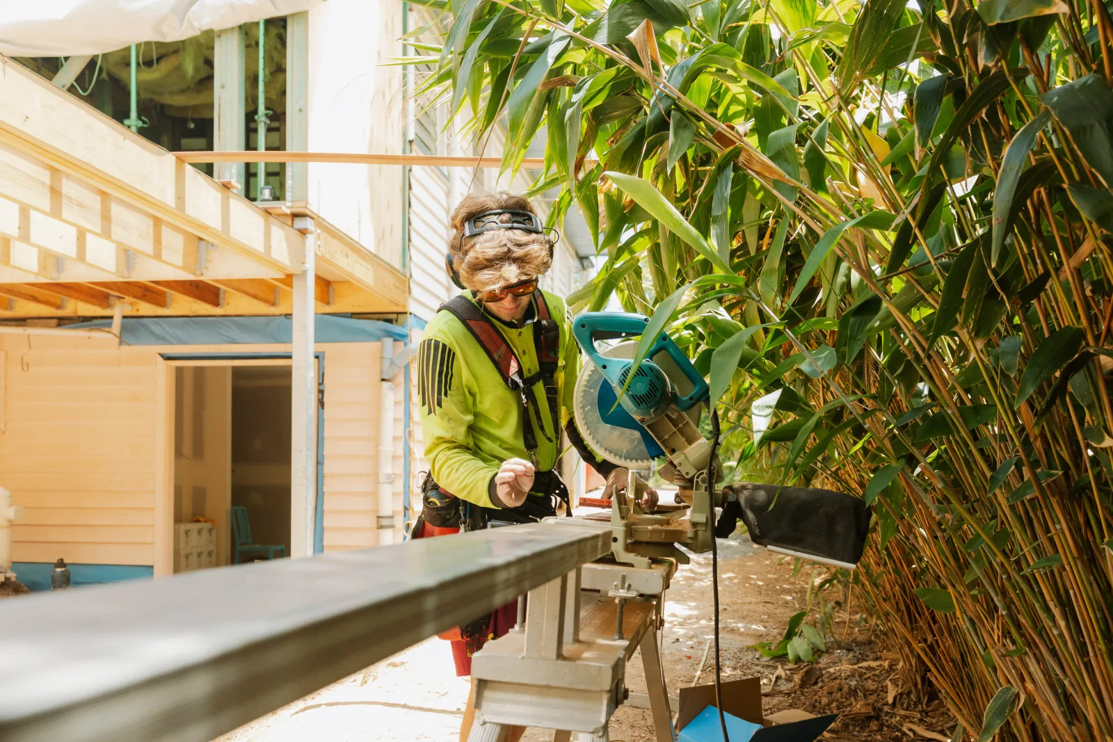 Carpenter using mitre saw during Brisbane house extension fit-out