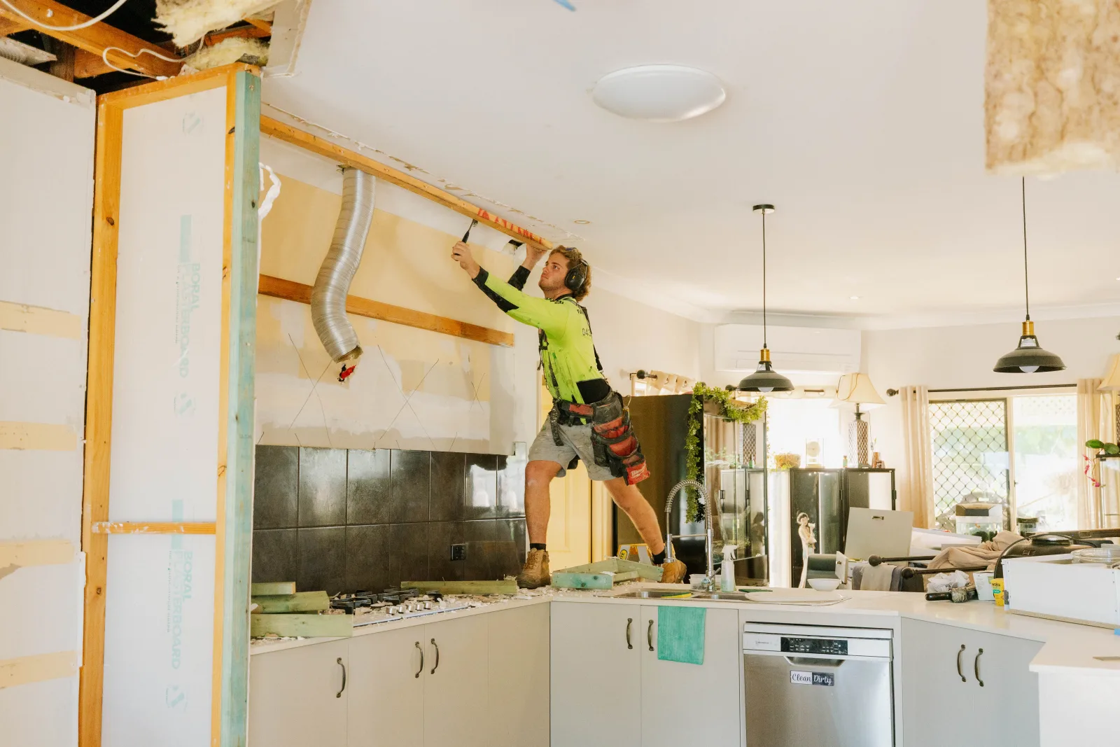 Tradesman working on kitchen ceiling renovation by Farr Constructions Brisbane