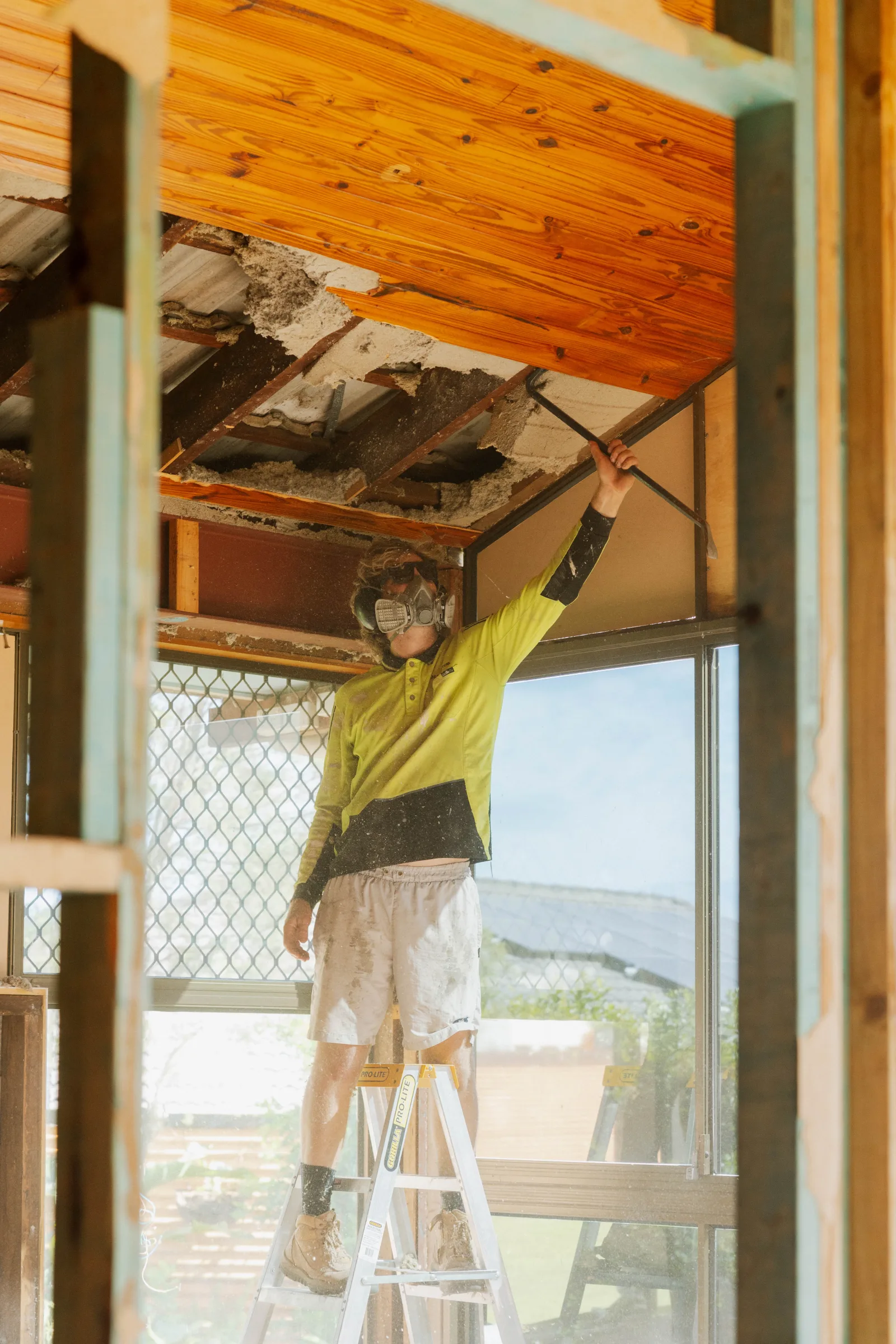 Tradesman installing ceiling during renovation build, Farr Constructions Brisbane