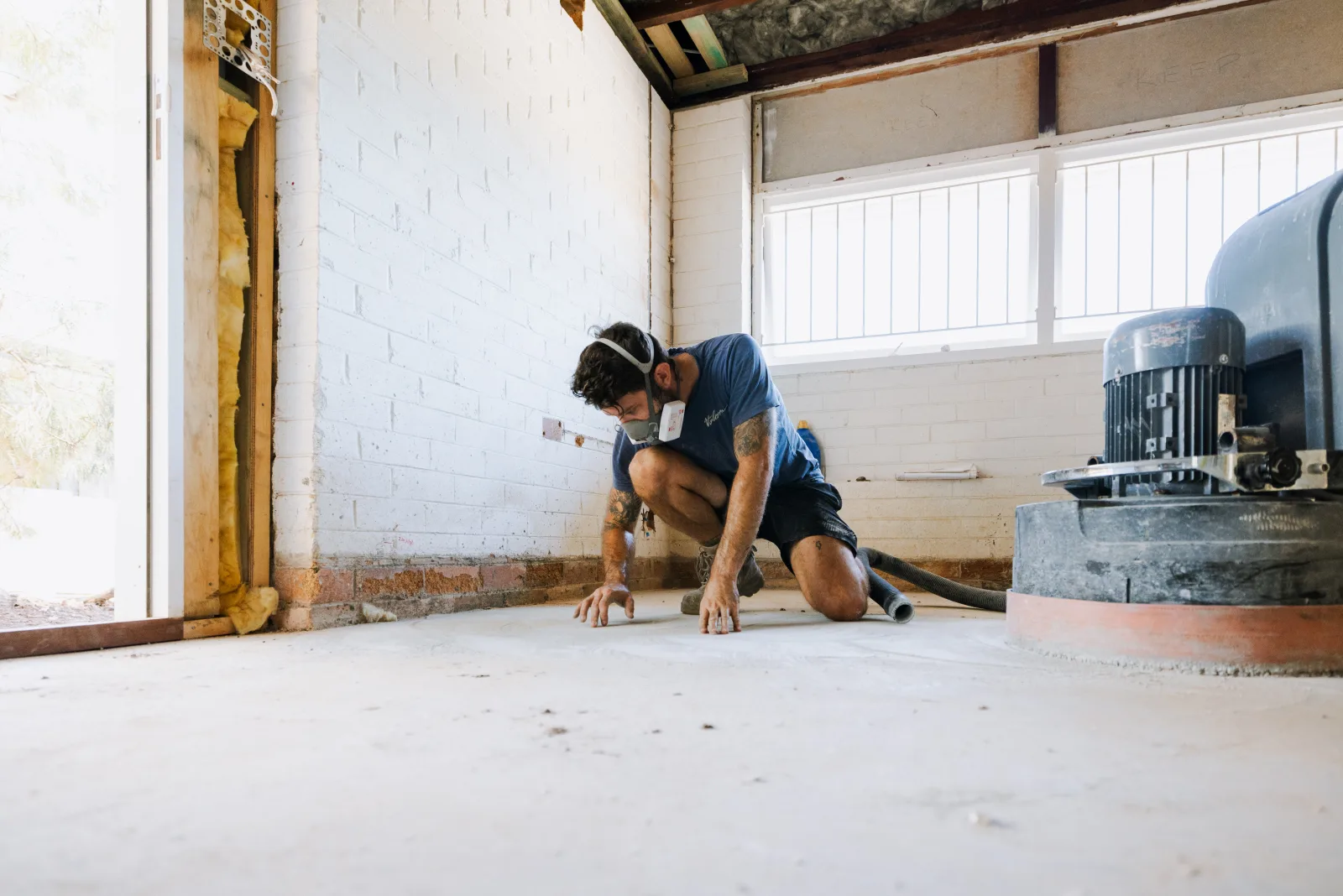 Tradesman inspecting renovation floor preparation, Farr Constructions Brisbane
