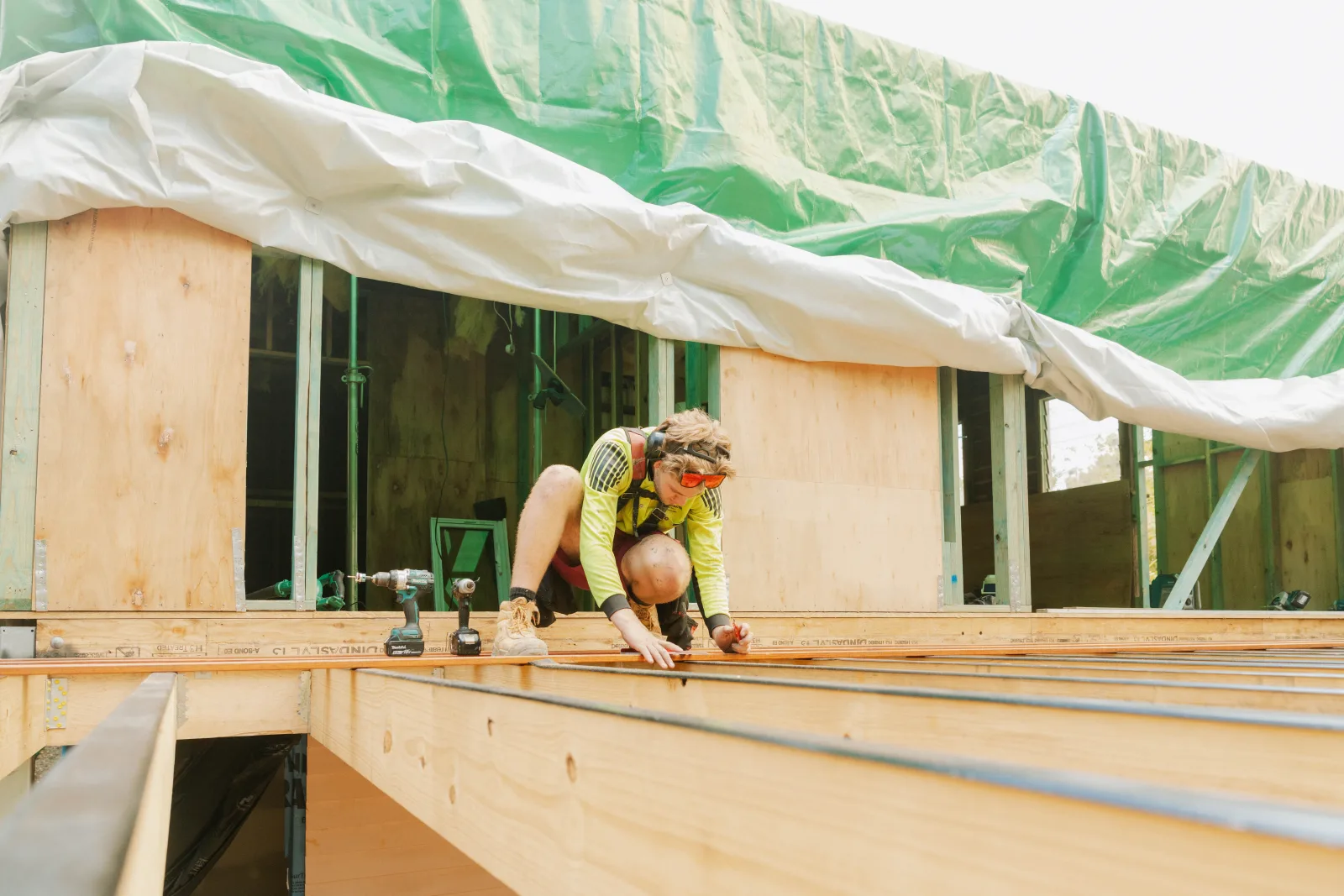 Tradesman framing roof deck during Brisbane house extension