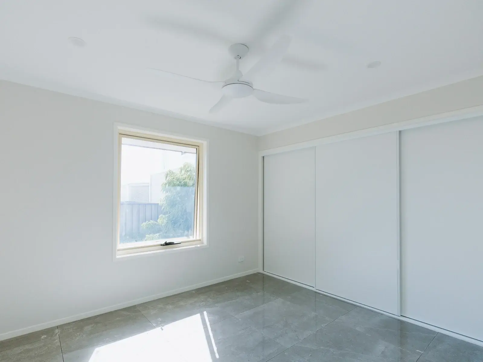 New master bedroom in house extension, Alexandra Hills Brisbane — tiled floor and built-in wardrobe