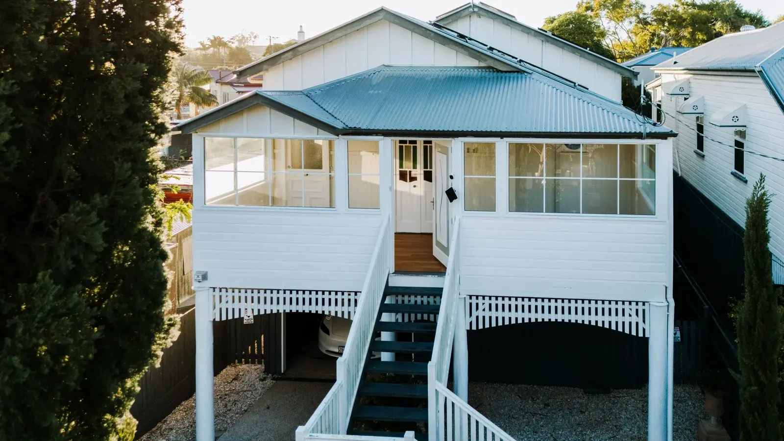 Completed enclosed Queenslander verandah exterior — new aluminium windows and cladding by Farr Constructions Brisbane