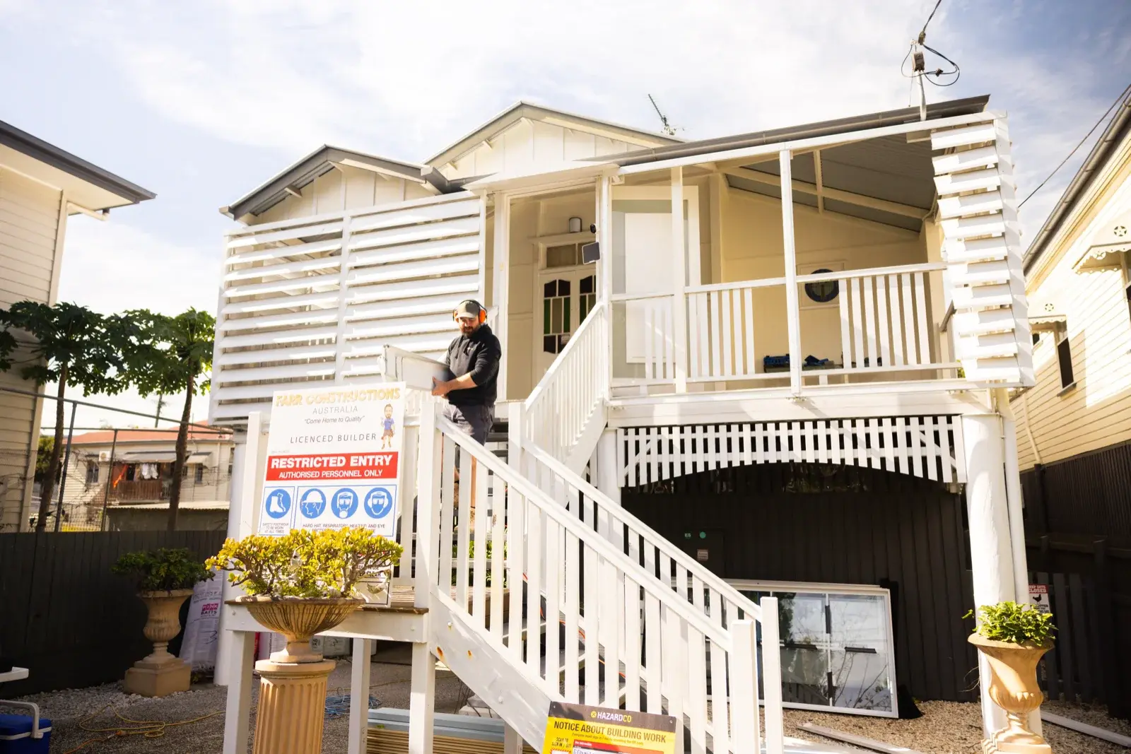 Queenslander verandah renovation in progress — Farr Constructions team on site enclosing the front verandah in Brisbane